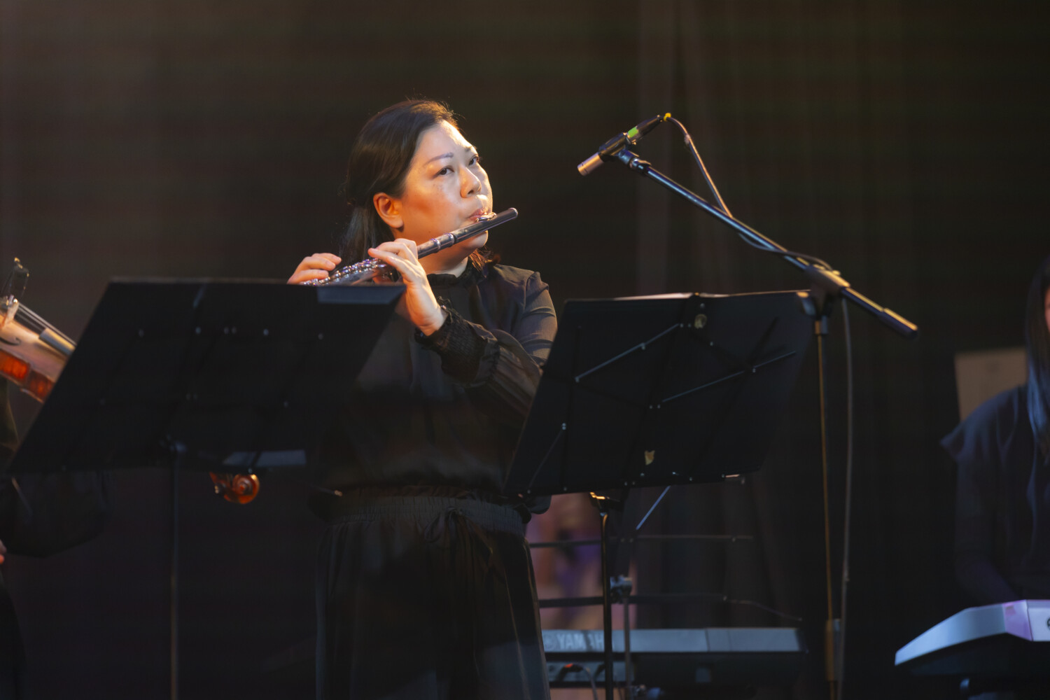 Senior flute instructor performing on stage Solaris Mont Kiara