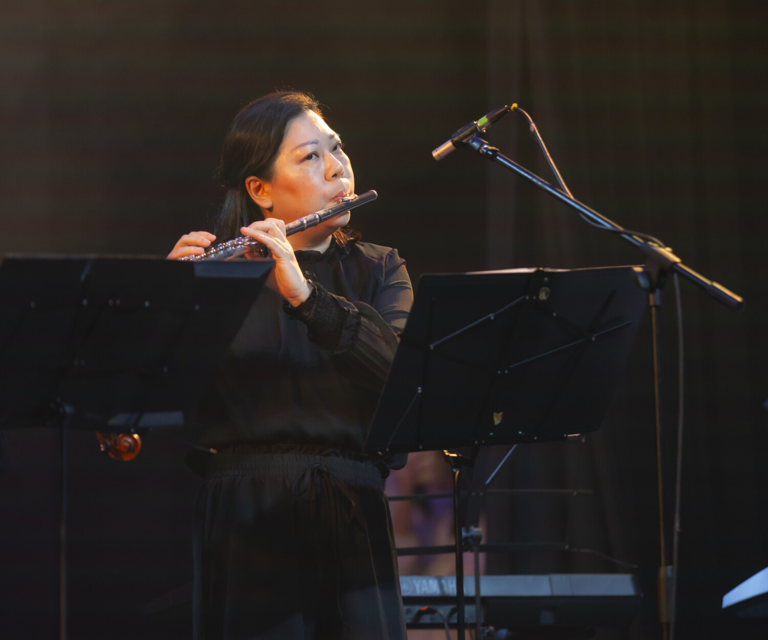 Senior flute instructor performing on stage Solaris Mont Kiara